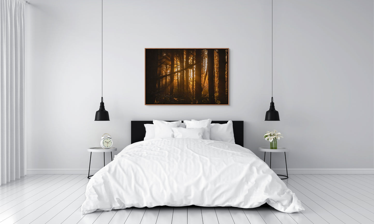 Bedroom with white bedding and a forest painting on the wall of sunlight filtering through trees at sunset in the forest at Long Beach, Tofino, BC. Cedar float frame.
