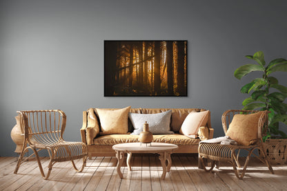 Living room with wicker furniture, a sofa, and a forest painting on the wall of sunlight filtering through trees at sunset in the forest at Long Beach, Tofino, BC. Black float frame.