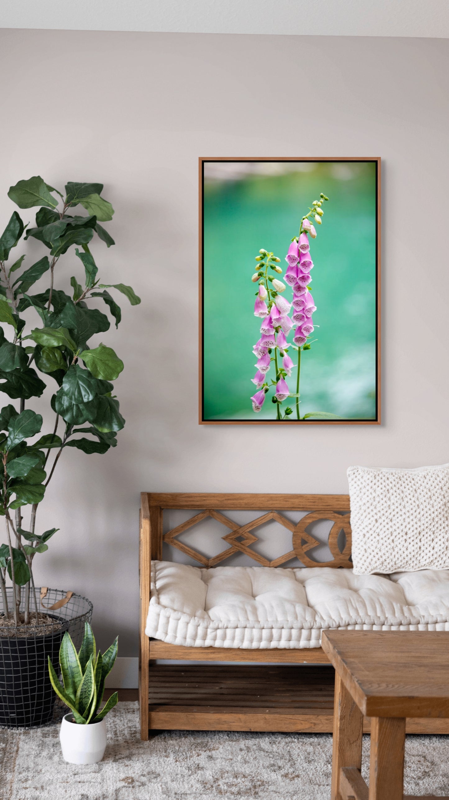 Living room with a wooden bench, potted plants, and a cedar framed picture of pink flowers on the wall.